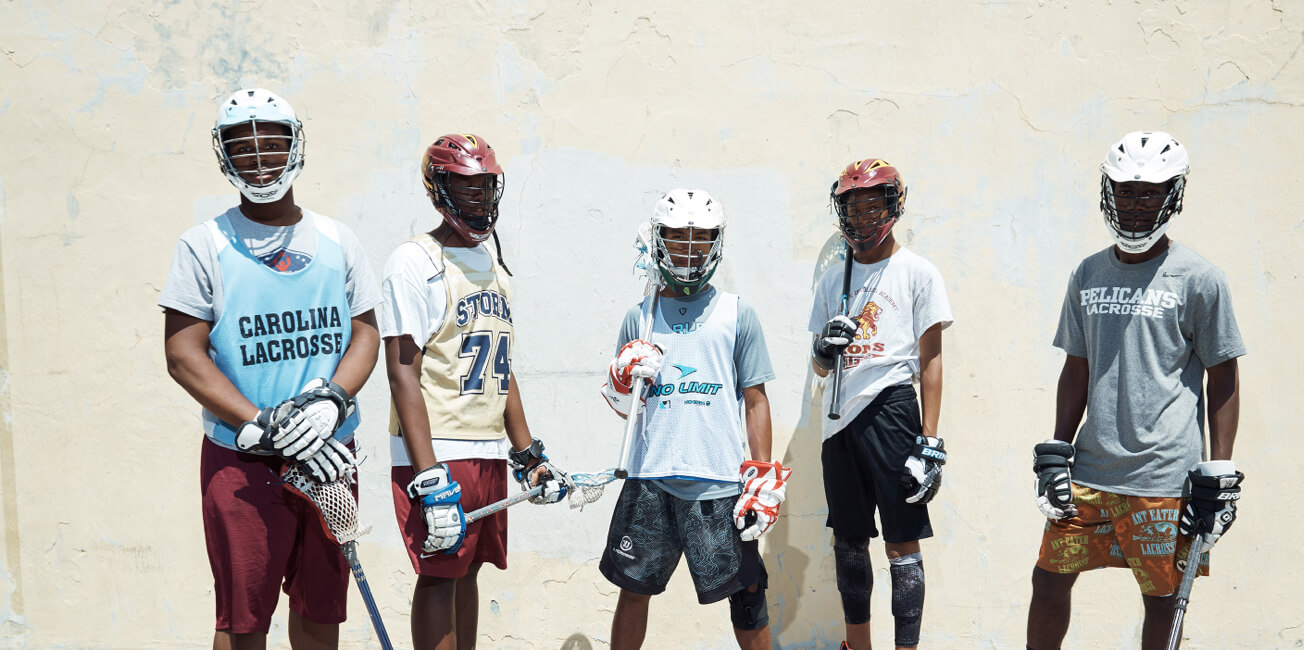 5 boys in Lacrosse gear